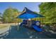 Community playground with slides and climbing structure features a sunshade for comfort and protection at 4446 Huntington Cir, Atlanta, GA 30338