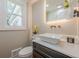 A stylish powder room featuring vessel sink, modern fixtures, and natural light at 4446 Huntington Cir, Atlanta, GA 30338