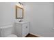 Bathroom featuring a white vanity with granite countertop, wood-look mirror and tile floors at 1824 Westwood Sw Ave, Atlanta, GA 30310