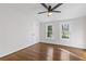 Light-filled bedroom featuring hardwood floors, two windows, and ceiling fan at 1824 Westwood Sw Ave, Atlanta, GA 30310