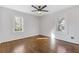 Bright bedroom features hardwood floors, fresh paint and updated ceiling fan and light fixture at 1824 Westwood Sw Ave, Atlanta, GA 30310