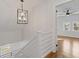 Light and airy hallway leads to bedrooms with hardwood floors and modern lighting at 1824 Westwood Sw Ave, Atlanta, GA 30310