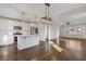 Bright, open-concept kitchen with white cabinets, stainless steel appliances, and hardwood floors leading to dining area at 1824 Westwood Sw Ave, Atlanta, GA 30310