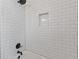 Modern shower stall featuring white subway tile and bronze fixtures at 1824 Westwood Sw Ave, Atlanta, GA 30310