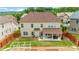 Aerial view of a backyard with a covered patio, swing set, and manicured lawn at 3652 Terrah Point Dr, Duluth, GA 30097