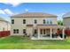 Backyard showcasing a covered patio with outdoor seating, a swing, and a manicured lawn at 3652 Terrah Point Dr, Duluth, GA 30097
