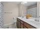 Well-lit bathroom featuring double sinks, dark wood cabinets, and a shower and tub combination at 3652 Terrah Point Dr, Duluth, GA 30097