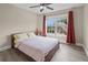 Bedroom featuring a ceiling fan, natural light, and a view of the outdoors at 3652 Terrah Point Dr, Duluth, GA 30097