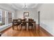 Elegant dining room featuring hardwood floors, tray ceiling, and a large window at 3652 Terrah Point Dr, Duluth, GA 30097