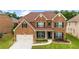 Beautiful brick two-story home featuring an attached two-car garage and landscaped front yard at 3652 Terrah Point Dr, Duluth, GA 30097