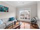 Sunlit living room with hardwood floors, contemporary furnishings, and a view of the neighborhood at 3652 Terrah Point Dr, Duluth, GA 30097