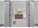 A luxurious main bathroom with double doors, a double vanity, a soaking tub, and tiled floors at 3652 Terrah Point Dr, Duluth, GA 30097