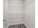Functional walk-in closet features neutral walls, white trim and hardware, and plenty of metal racks for storage at 3652 Terrah Point Dr, Duluth, GA 30097