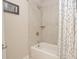 Clean bathroom featuring a shower and tub with neutral tile and decorative shower curtain at 4000 Chastain Preserve Ne Way, Atlanta, GA 30342