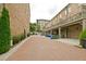 Rear of townhome with brick paved street leading to covered parking and private balconies at 4000 Chastain Preserve Ne Way, Atlanta, GA 30342