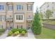 Attractive townhome featuring a well-maintained front lawn, traditional windows, and classic shutters at 4000 Chastain Preserve Ne Way, Atlanta, GA 30342