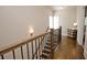 Hallway boasts gleaming hardwood floors, wooden banister, and neutral paint at 4000 Chastain Preserve Ne Way, Atlanta, GA 30342