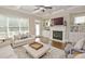 Bright living room with fireplace, hardwood floors, coffered ceilings, and large windows at 4000 Chastain Preserve Ne Way, Atlanta, GA 30342