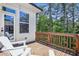 Relaxing balcony area featuring two Adirondack chairs and beautiful backyard views at 408 Townly Ct, Alpharetta, GA 30009