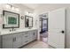 Elegant bathroom featuring double vanity, modern fixtures, and an open doorway leading to the bedroom at 408 Townly Ct, Alpharetta, GA 30009