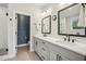 Bathroom featuring a double vanity, modern fixtures, and a walk-in shower with decorative tile at 408 Townly Ct, Alpharetta, GA 30009