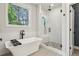 Bright bathroom featuring a standalone tub, glass shower, and modern fixtures with plenty of natural light at 408 Townly Ct, Alpharetta, GA 30009