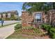 Elegant brick sign marking the entrance to the community, surrounded by vibrant landscaping at 408 Townly Ct, Alpharetta, GA 30009