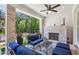 Charming covered patio boasts a brick fireplace, ceiling fan, and comfortable seating for delightful outdoor gatherings at 408 Townly Ct, Alpharetta, GA 30009