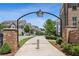 Welcoming entrance to the community with beautiful brick accents and manicured landscaping at 408 Townly Ct, Alpharetta, GA 30009