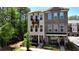 Beautiful townhome with a balcony and covered patio, accented by manicured landscaping and a sleek black fence at 408 Townly Ct, Alpharetta, GA 30009