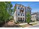 Charming townhome showcasing a light brick facade, balcony, and a manicured front yard with black metal fencing at 408 Townly Ct, Alpharetta, GA 30009