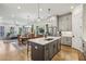 Open floor plan shows kitchen with gray cabinets, large island with seating, and stainless steel appliances at 408 Townly Ct, Alpharetta, GA 30009