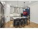 Kitchen featuring a large island with seating, gray cabinets, stainless steel appliances, and hardwood flooring at 408 Townly Ct, Alpharetta, GA 30009
