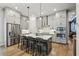A kitchen features gray cabinets, stainless steel appliances, and a large island with seating for four at 408 Townly Ct, Alpharetta, GA 30009