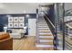 Inviting living room featuring hardwood floors, staircase, and stylish decor, creating a warm and welcoming ambiance at 408 Townly Ct, Alpharetta, GA 30009