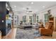 Living room featuring a fireplace, hardwood floors, and a comfortable sofa with decorative pillows at 408 Townly Ct, Alpharetta, GA 30009
