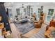 Bright living room with hardwood floors, neutral paint, large windows, and a comfortable sectional sofa at 408 Townly Ct, Alpharetta, GA 30009