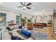 Spacious living room featuring fireplace and hardwood floors with an open concept to the dining and kitchen areas at 408 Townly Ct, Alpharetta, GA 30009