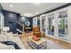 Stylish living room with hardwood floors, neutral sofa, accent chair, and access to a covered patio at 408 Townly Ct, Alpharetta, GA 30009
