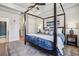 Spacious main bedroom with tray ceilings, natural lighting, and an elegant four-poster bed with stylish decor at 408 Townly Ct, Alpharetta, GA 30009