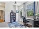 Bright office featuring a desk, chair, bookshelf, with a door leading to an outdoor balcony at 408 Townly Ct, Alpharetta, GA 30009