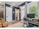 Home office features a large desk, modern chair, navy walls, and a door that leads to an outdoor patio at 408 Townly Ct, Alpharetta, GA 30009