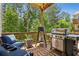 Outdoor patio with a stainless steel grill and comfortable seating, ideal for entertaining and relaxation at 408 Townly Ct, Alpharetta, GA 30009