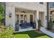 Inviting covered patio with stylish seating, lush plants, and ceiling fan for comfortable outdoor relaxation at 408 Townly Ct, Alpharetta, GA 30009