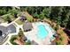 Aerial view of a community pool with lounge chairs, landscaping, and a covered patio area at 408 Townly Ct, Alpharetta, GA 30009