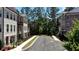 View of charming townhomes and manicured landscaping in a picturesque neighborhood at 408 Townly Ct, Alpharetta, GA 30009
