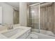 This bathroom features a sink with vanity and a shower-tub combination with glass doors at 147 Longleaf Dr, Canton, GA 30114