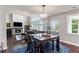 Open dining room with view to living room fireplace, hardwood floors and lots of natural light at 147 Longleaf Dr, Canton, GA 30114
