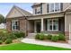 Inviting front porch with stone accents, manicured landscaping, and an elegant entrance, creating curb appeal at 147 Longleaf Dr, Canton, GA 30114