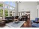 Spacious living room with high ceilings, large windows, hardwood floors, and a view into the modern kitchen at 147 Longleaf Dr, Canton, GA 30114